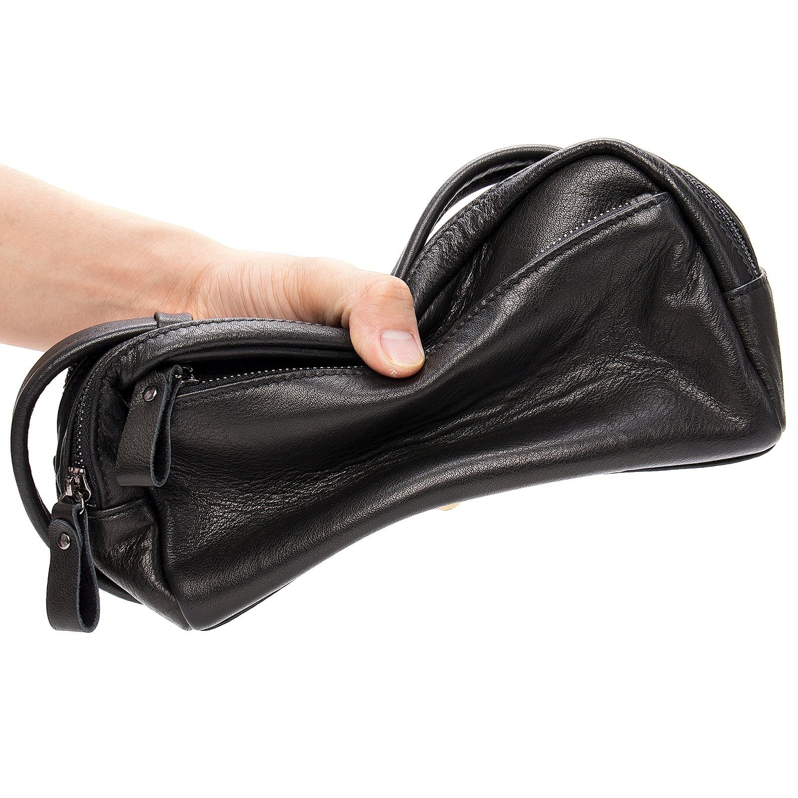 Barcon Getta black leather toiletry bag with multiple compartments and zippers, held in hand.