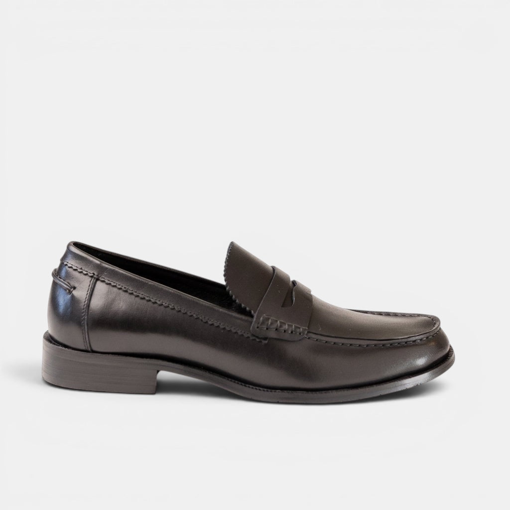 Barcon Getta Inc ABUJA black leather penny loafers with traditional strap detail and sleek silhouette.