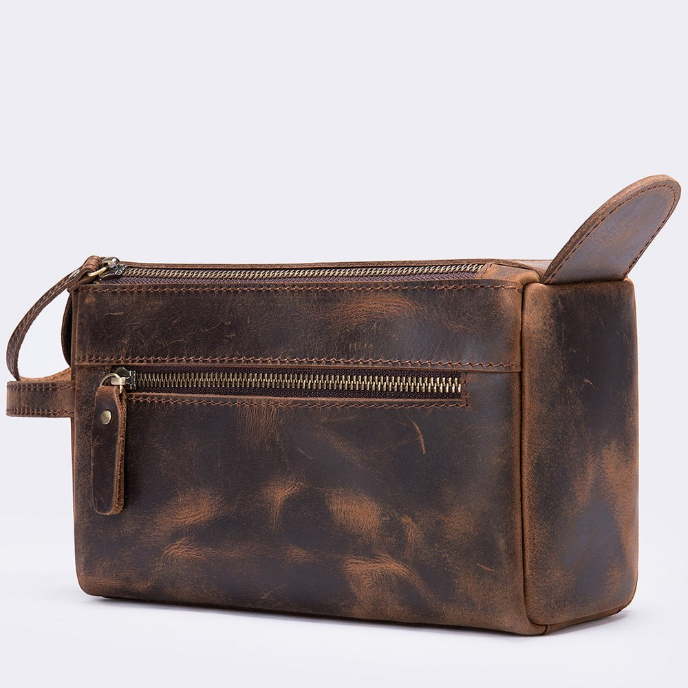 Barcon Getta Inc TERRAIN Dopp Case, a dark brown distressed full grain leather toiletry bag with multiple zippered compartments and a convenient side handle.