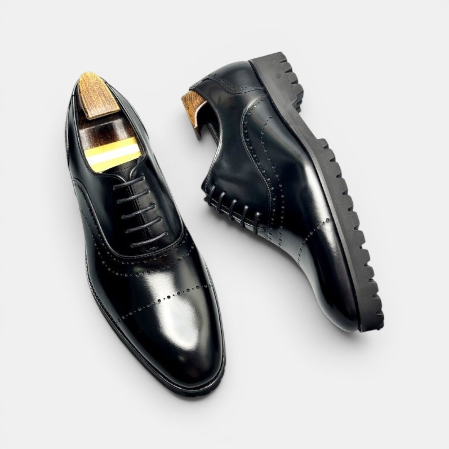 Barcon Getta Inc BANJUL black full grain leather wingtip oxford dress shoes with lug sole.