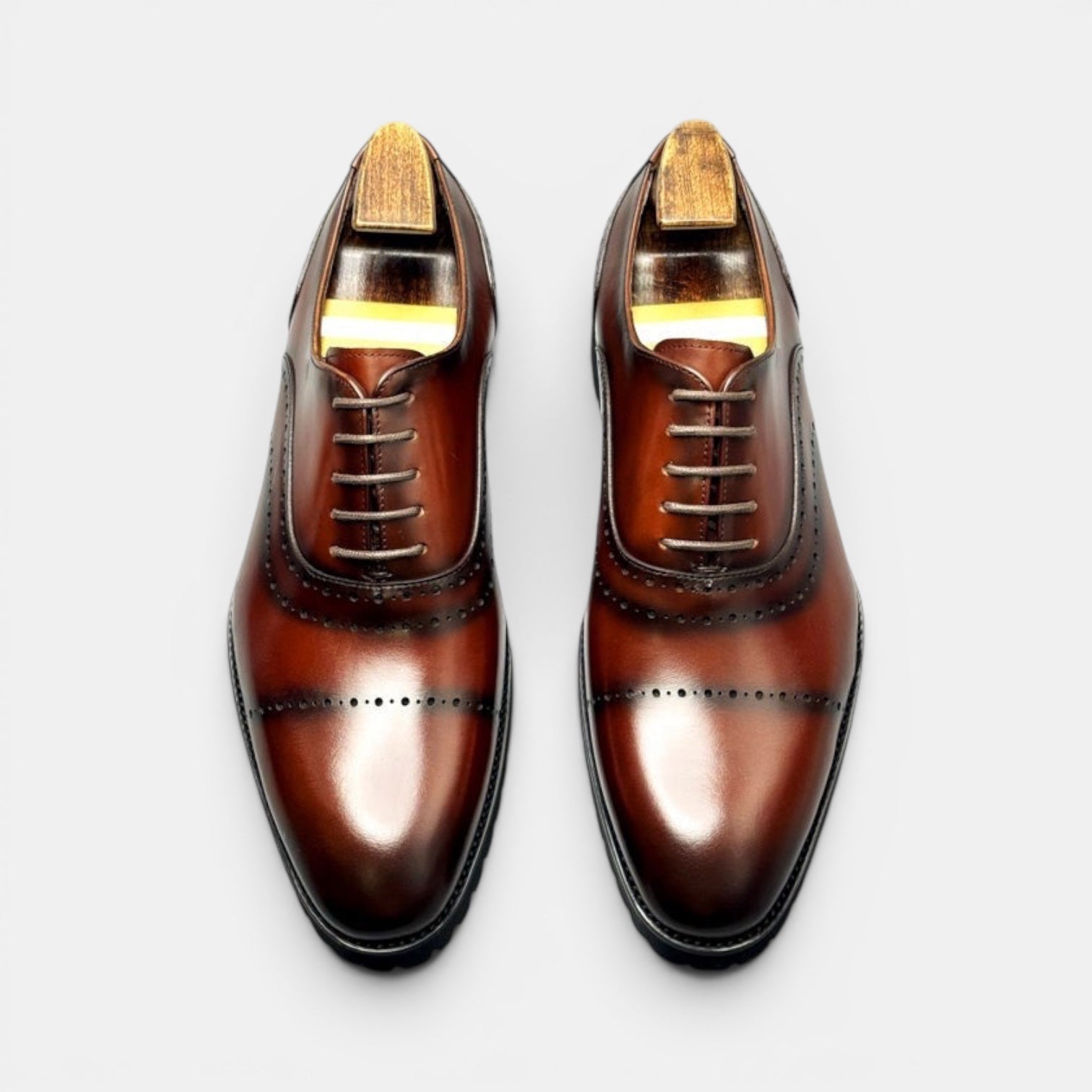 Barcon Getta Inc BANJUL cognac brown leather wingtip Oxford dress shoes with brogue perforations and lug sole.