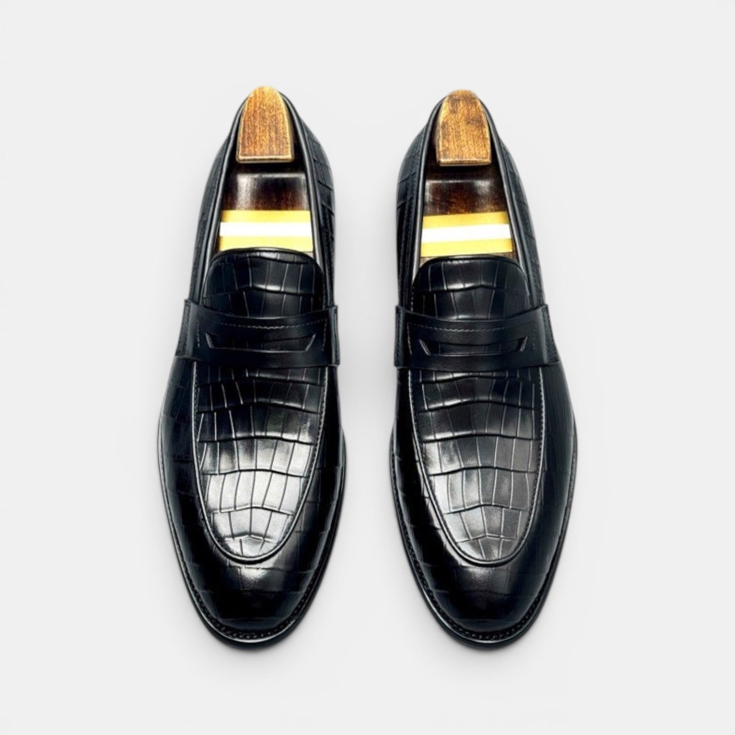 Barcon Getta Inc BRAZZAVILLE black leather crocodile-embossed penny loafers with wooden shoe trees.