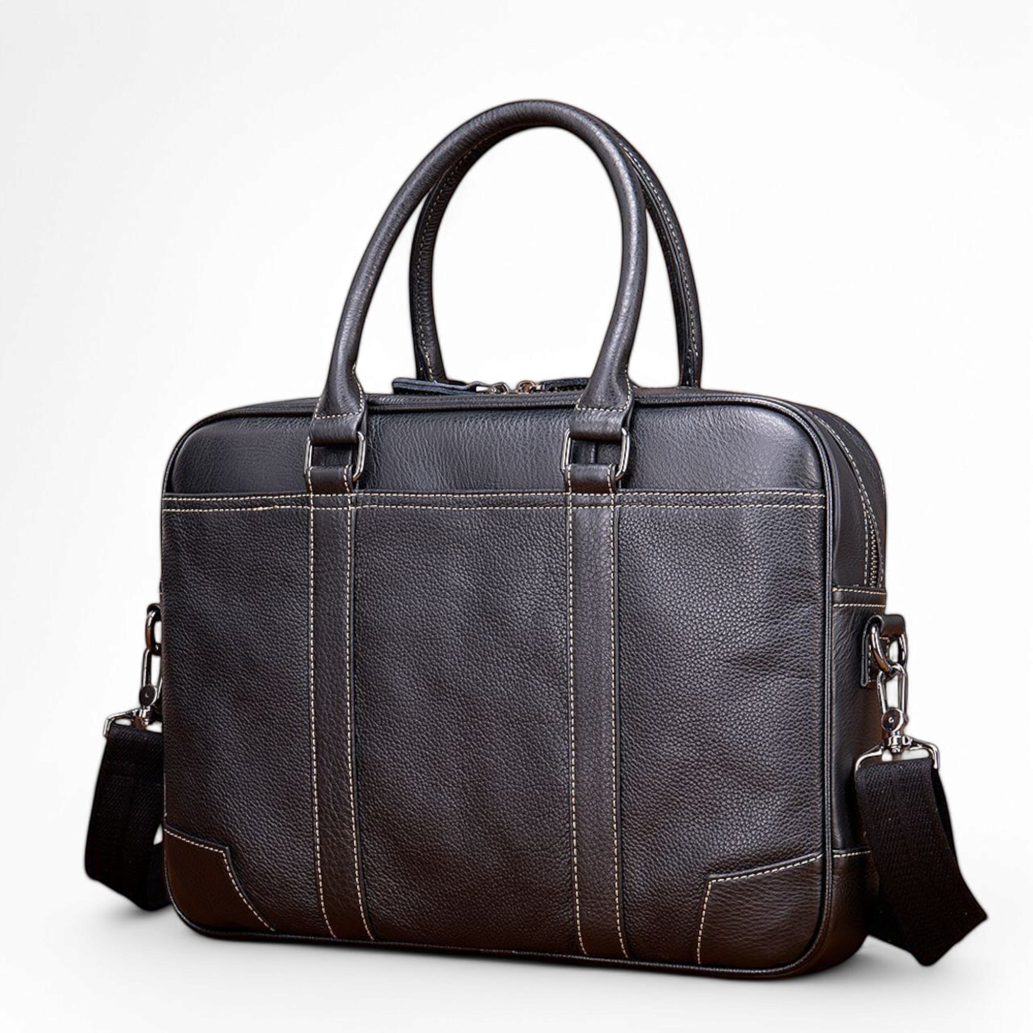 Barcon Getta Inc black leather briefcase with contrast stitching, top handles, and detachable shoulder strap. Fits up to 16" laptop.