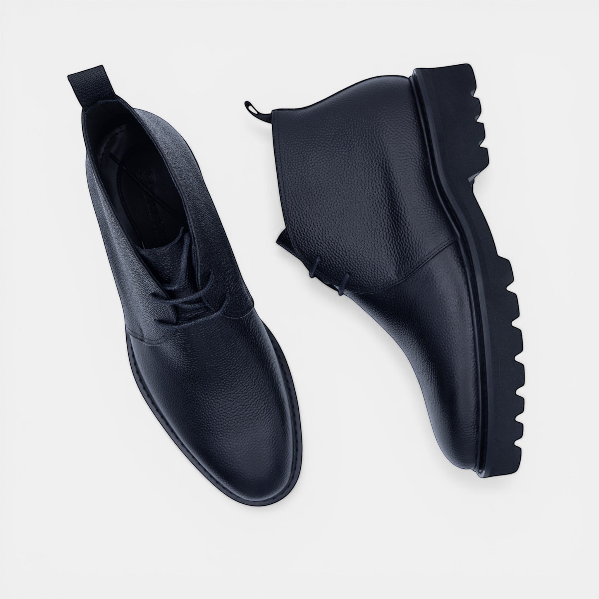 Barcon Getta Inc black textured leather chukka boots with lug sole and lace-up closure.