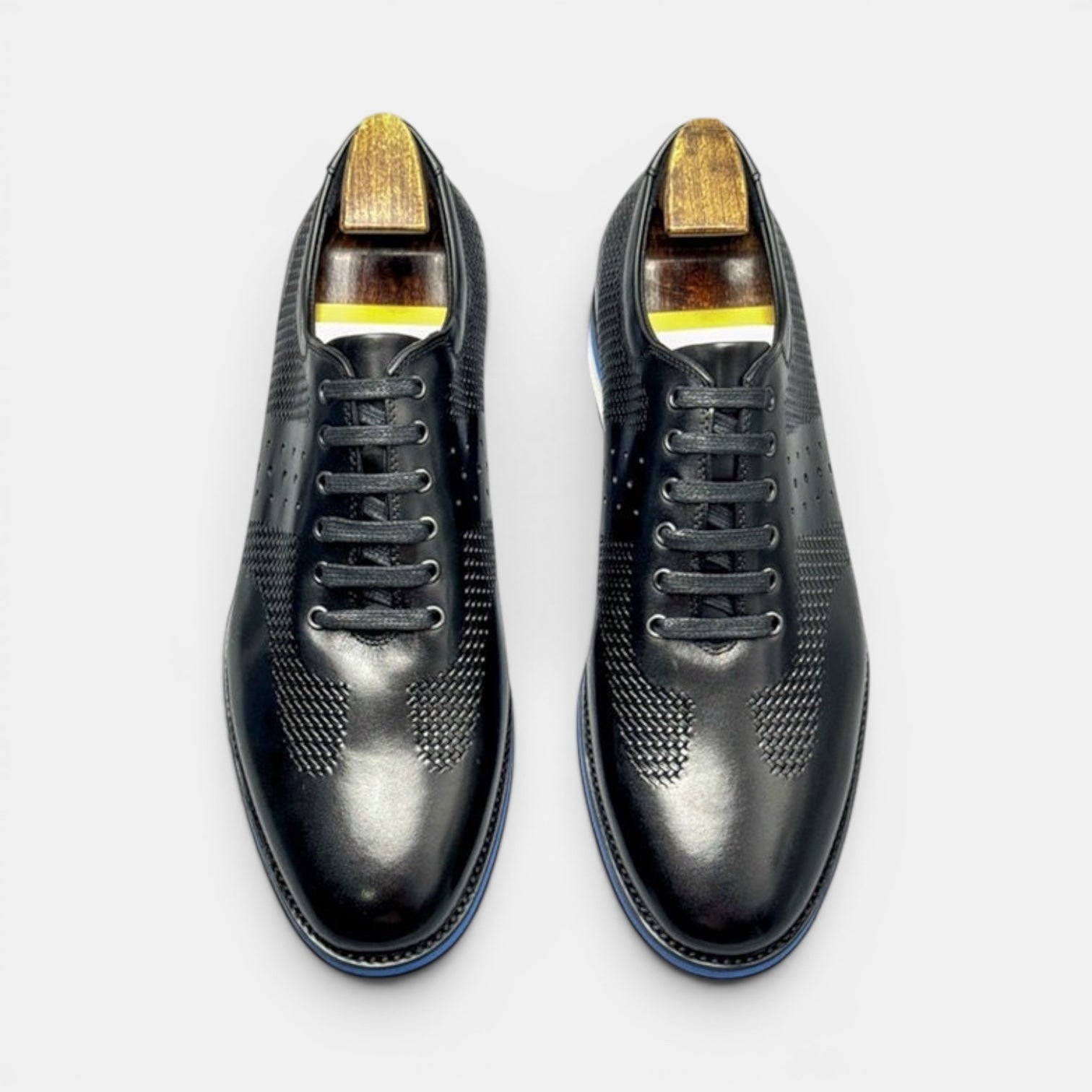 Barcon Getta Inc black full grain leather dress shoes with sneaker sole, perforated toe, and embossed check quarter.