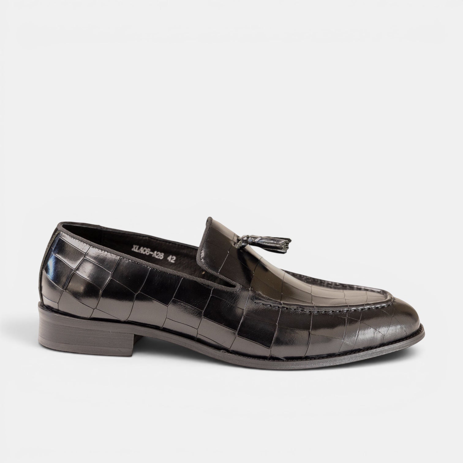 Barcon Getta Inc black croc-embossed leather tassel loafer with silk tassel and rubber sole.