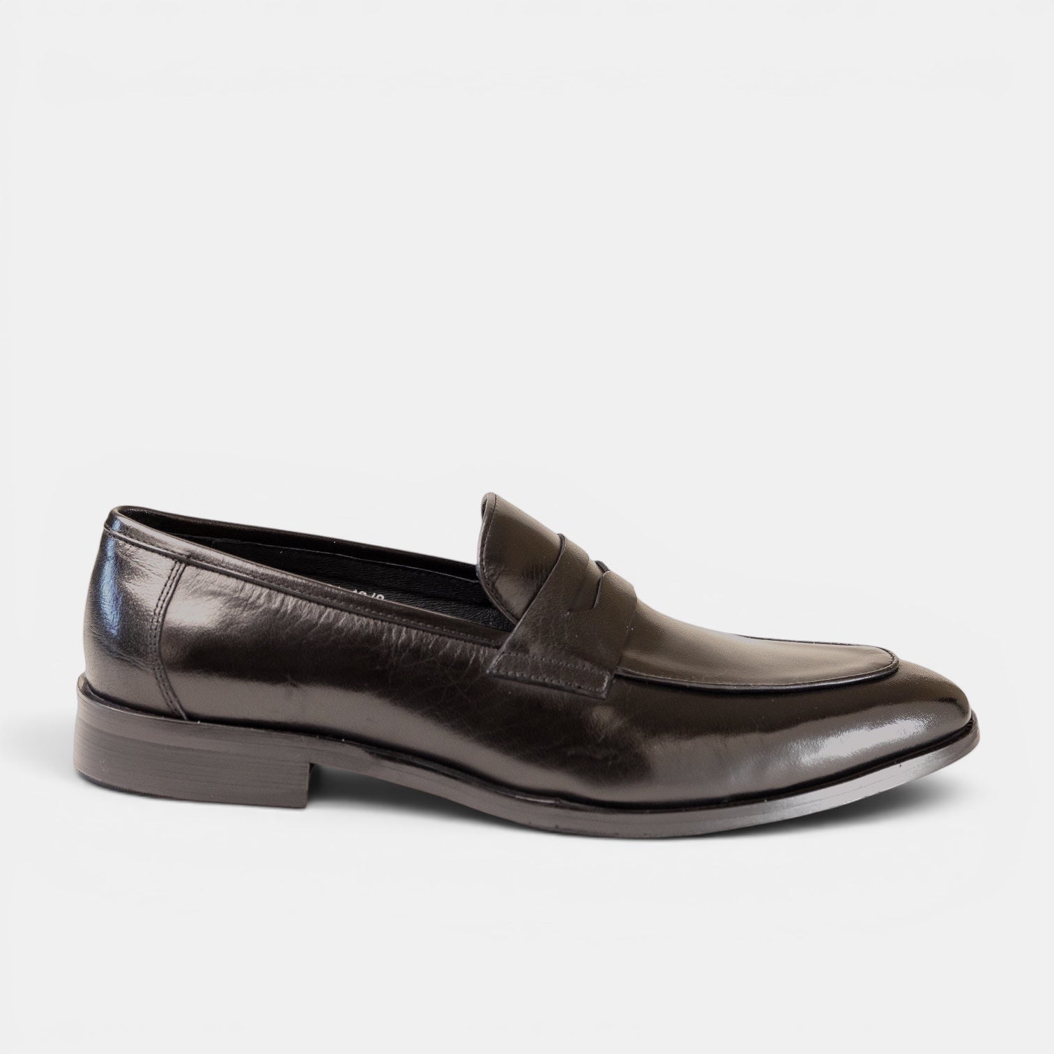 Barcon Getta Inc MONROVIA black polished leather penny loafers with a sleek silhouette and traditional strap.