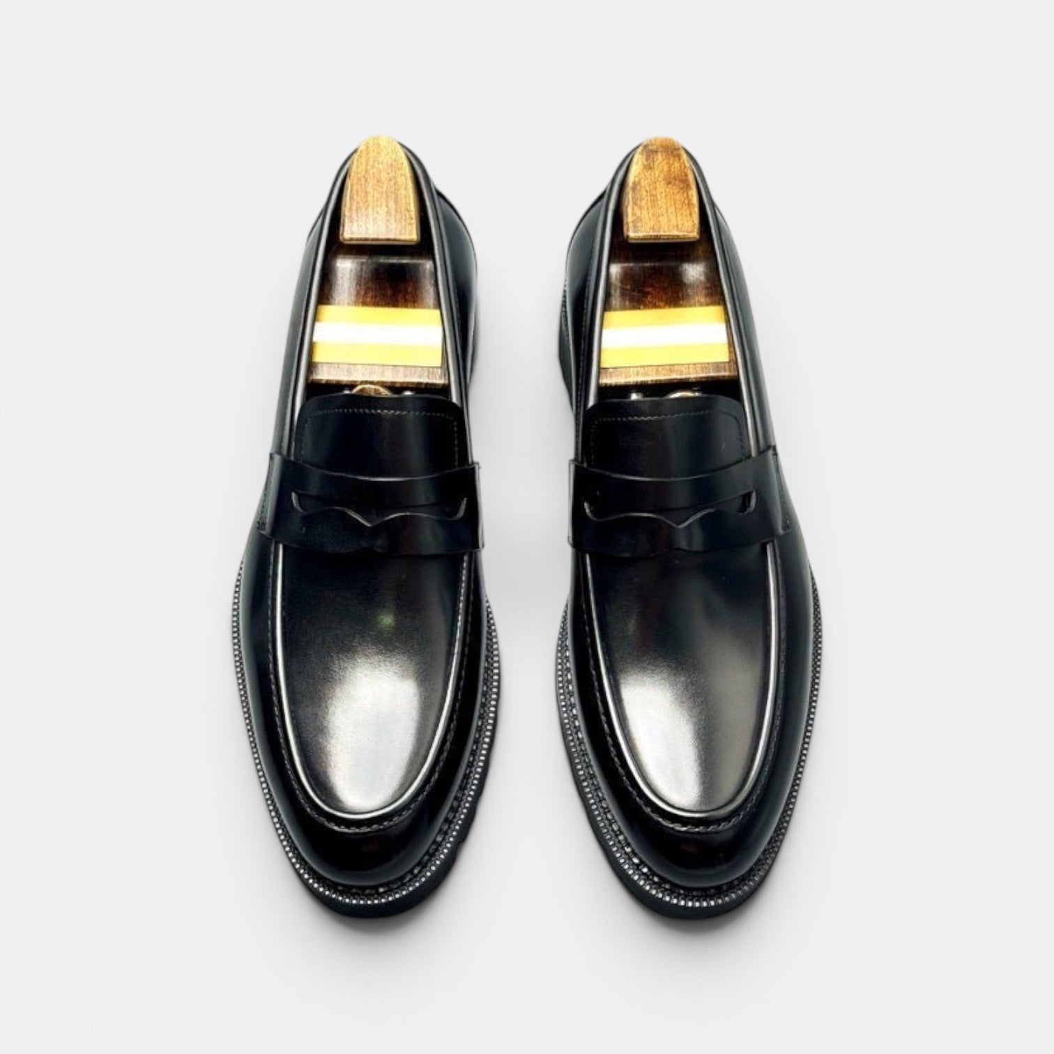 Barcon Getta Inc NIAMEY black polished leather penny loafers with lug sole and wooden shoe trees.