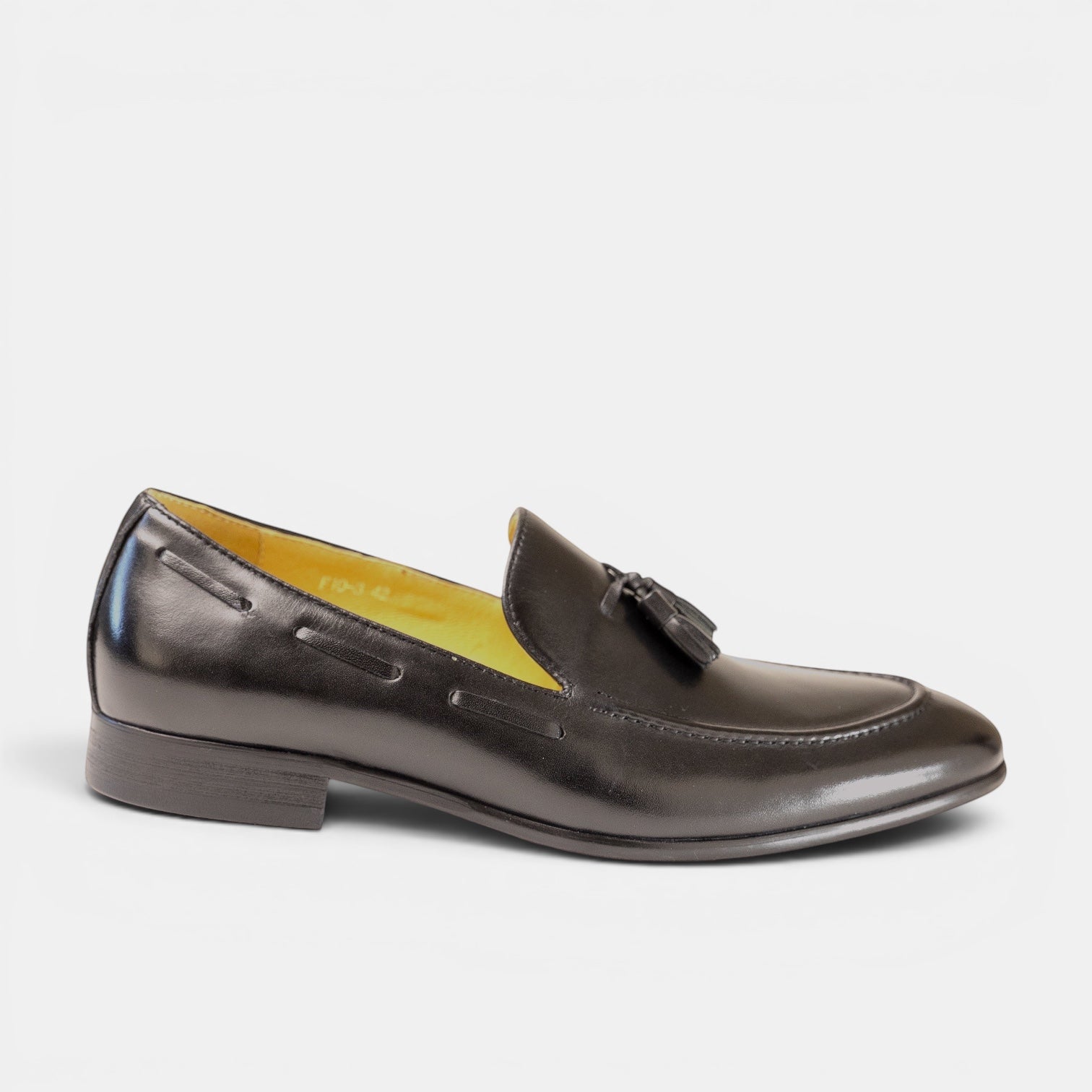 Barcon Getta Inc black full grain leather tassel loafer with bright amber lining and patent-like finish.