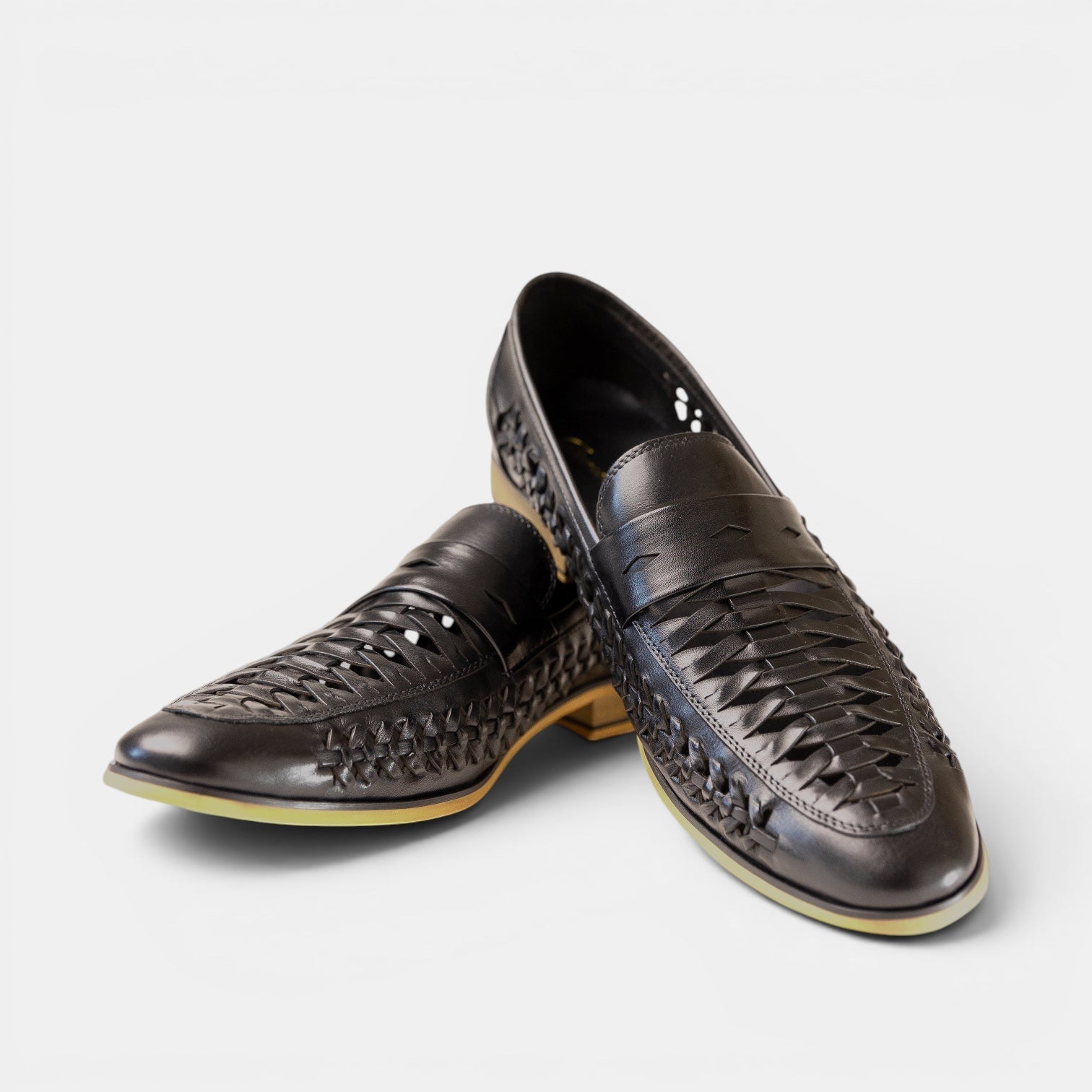 Barcon Getta Inc black leather woven slip-on loafers with a classic silhouette and breathable design.