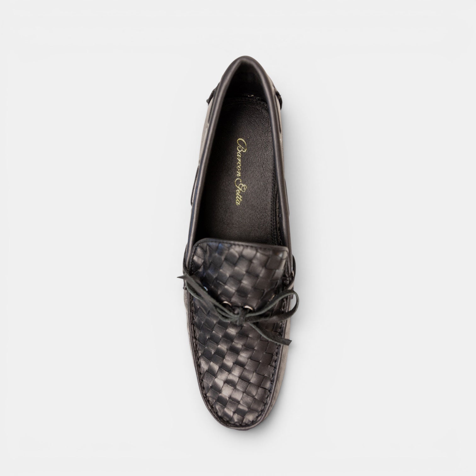 Barcon Getta Inc black woven full grain leather driving moccasins with a bow detail and gunmetal eyelets.