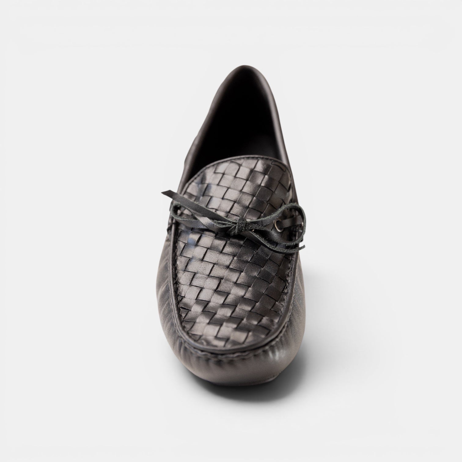 Barcon Getta Inc black woven leather driving moccasins with a bow detail and gunmetal eyelets.
