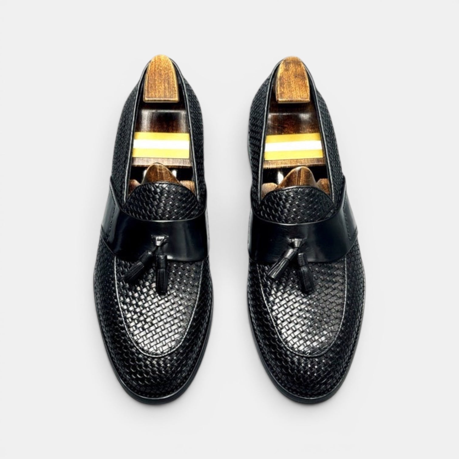 Barcon Getta Inc black woven leather tassel loafers with smooth leather strap and wooden shoe trees.