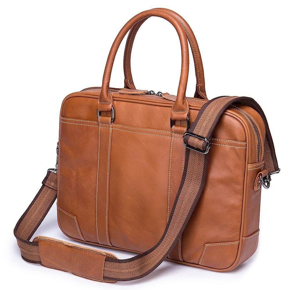 Barcon Getta Inc brown Ethiopian leather briefcase with white stitching, adjustable strap, and multiple pockets. Fits up to 16" laptop.
