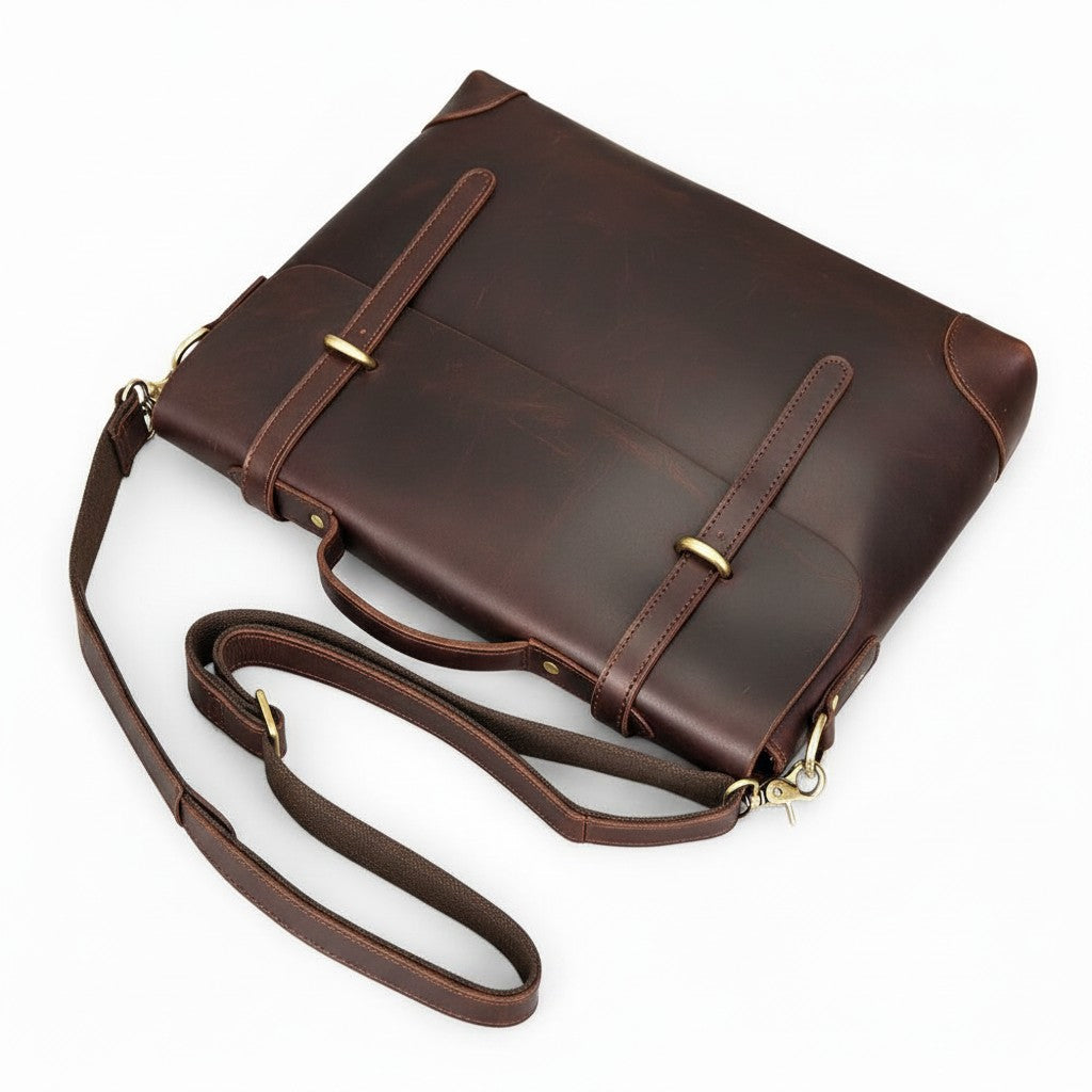 Barcon Getta Inc MANGECHA brown full grain leather messenger bag with adjustable strap and multiple pockets.