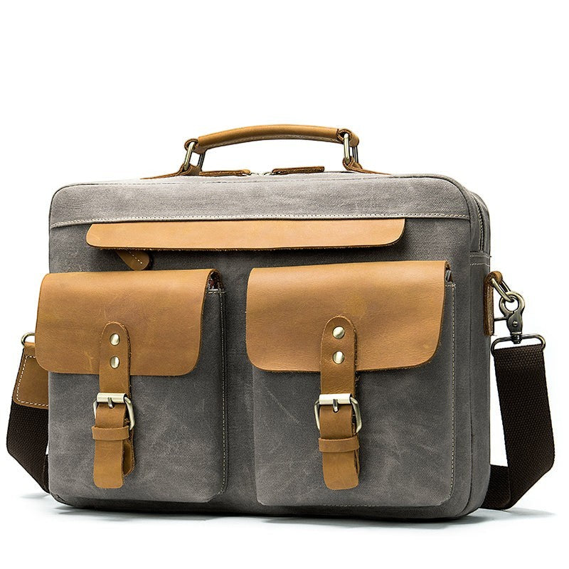 Barcon Getta Inc THE CLASSIC grey canvas messenger bag with tan leather accents, buckle flap pockets, and top handle.