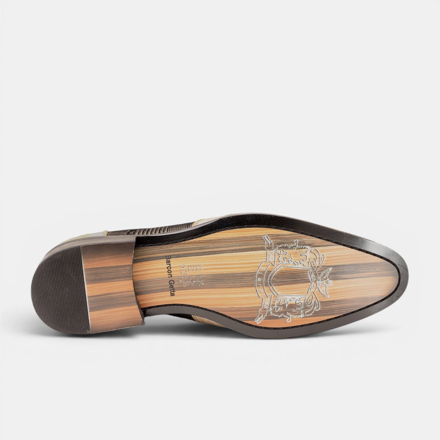 Barcon Getta Inc DAKAR suede wingtip Oxford dress shoe sole with wood grain pattern and crest branding.