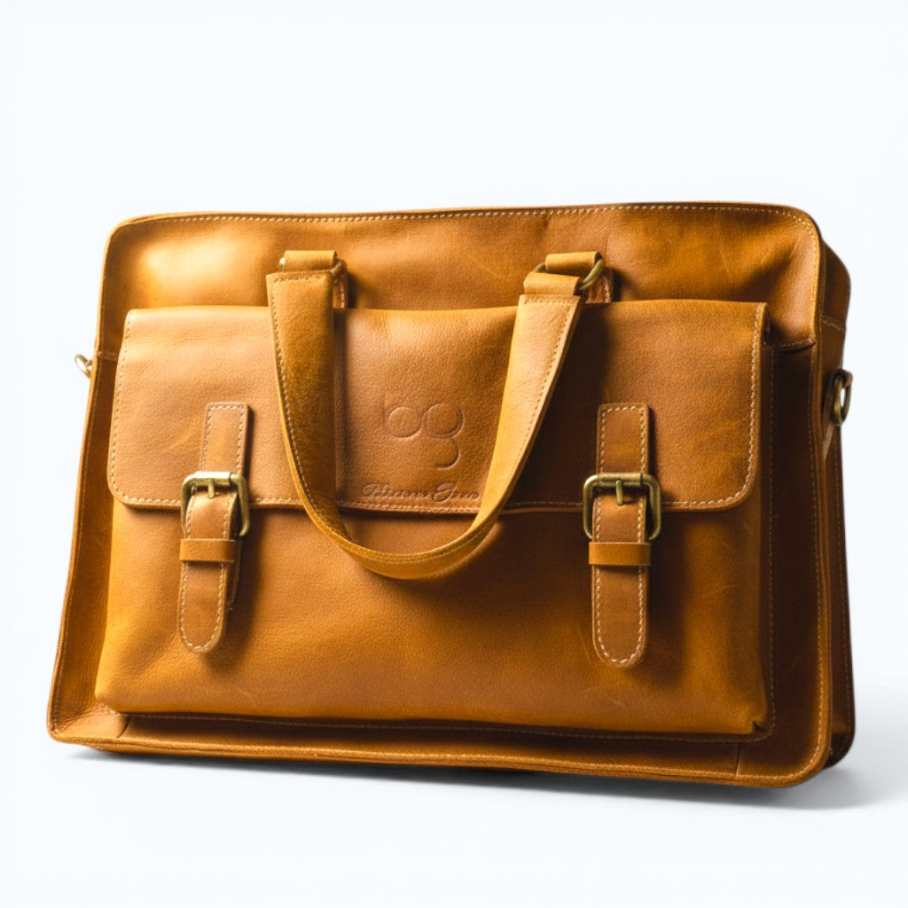 Barcon Getta Inc GEMEL tan leather briefcase with buckle closures, top handles, and multiple pockets. Fits up to 14" laptop.