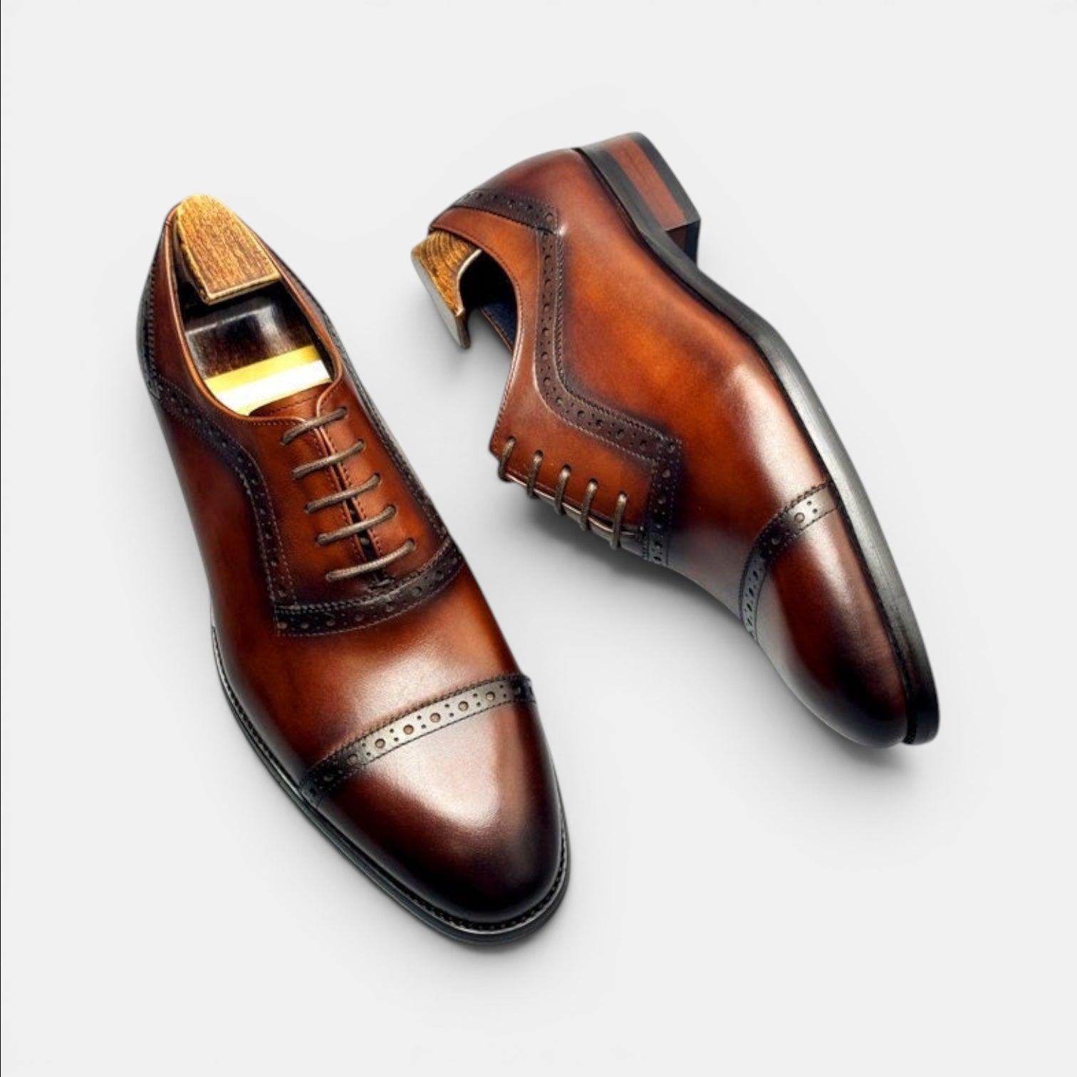 Barcon Getta Inc GITEGA Oxford cap toe dress shoes in hand-burnished brown full grain leather with brogue detailing.
