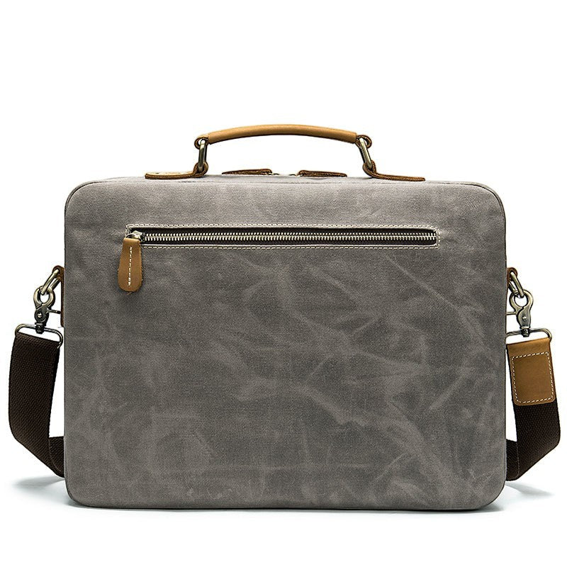 Barcon Getta Inc THE CLASSIC grey canvas messenger bag with tan leather accents and buckle pockets.