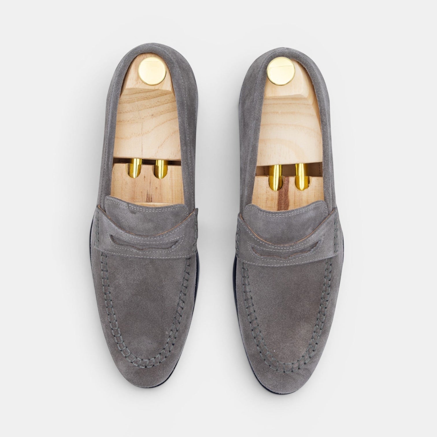 Barcon Getta Inc grey suede penny loafers with hand-stitched moccasin toe and tan leather insole.