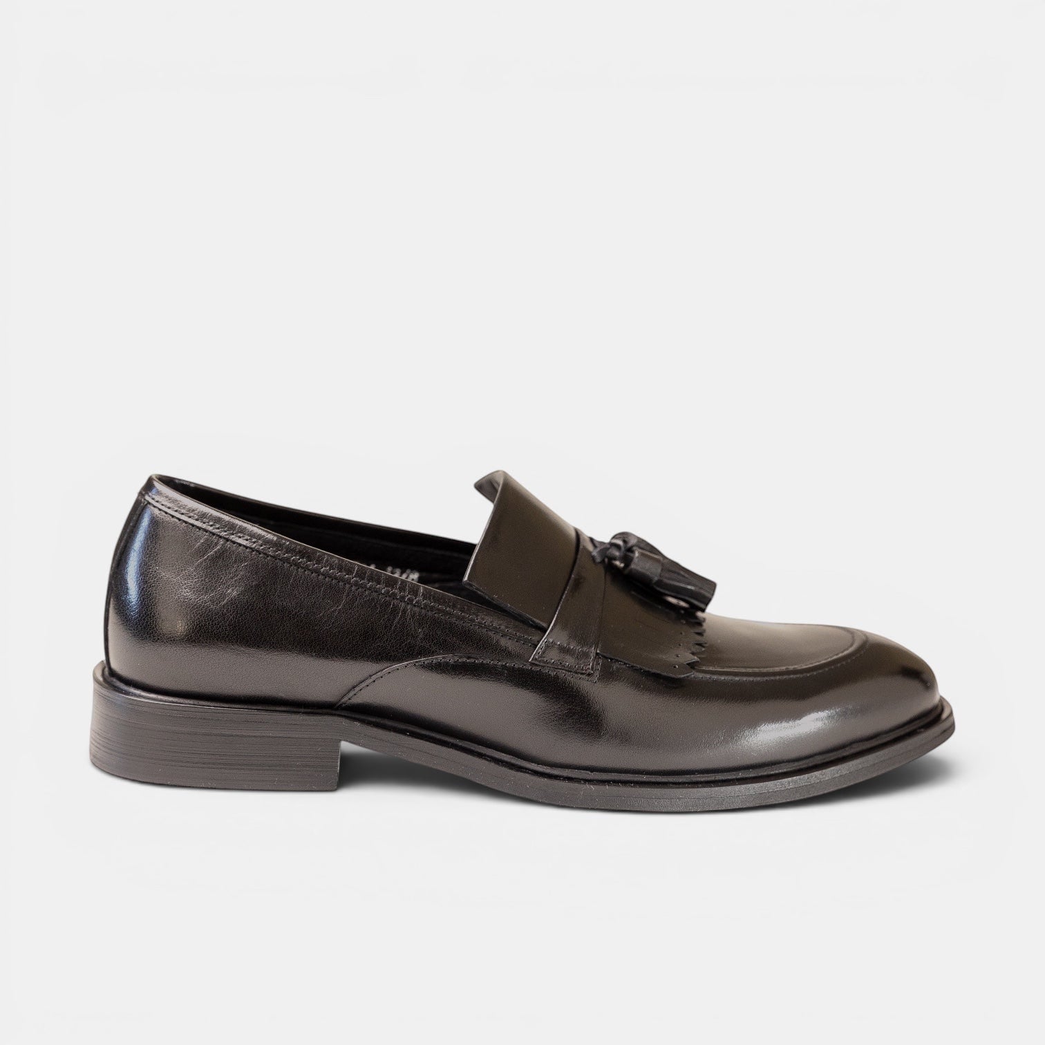 Barcon Getta Inc KUMASSI black full-grain leather tassel loafers with a high-shine mirror polish finish.