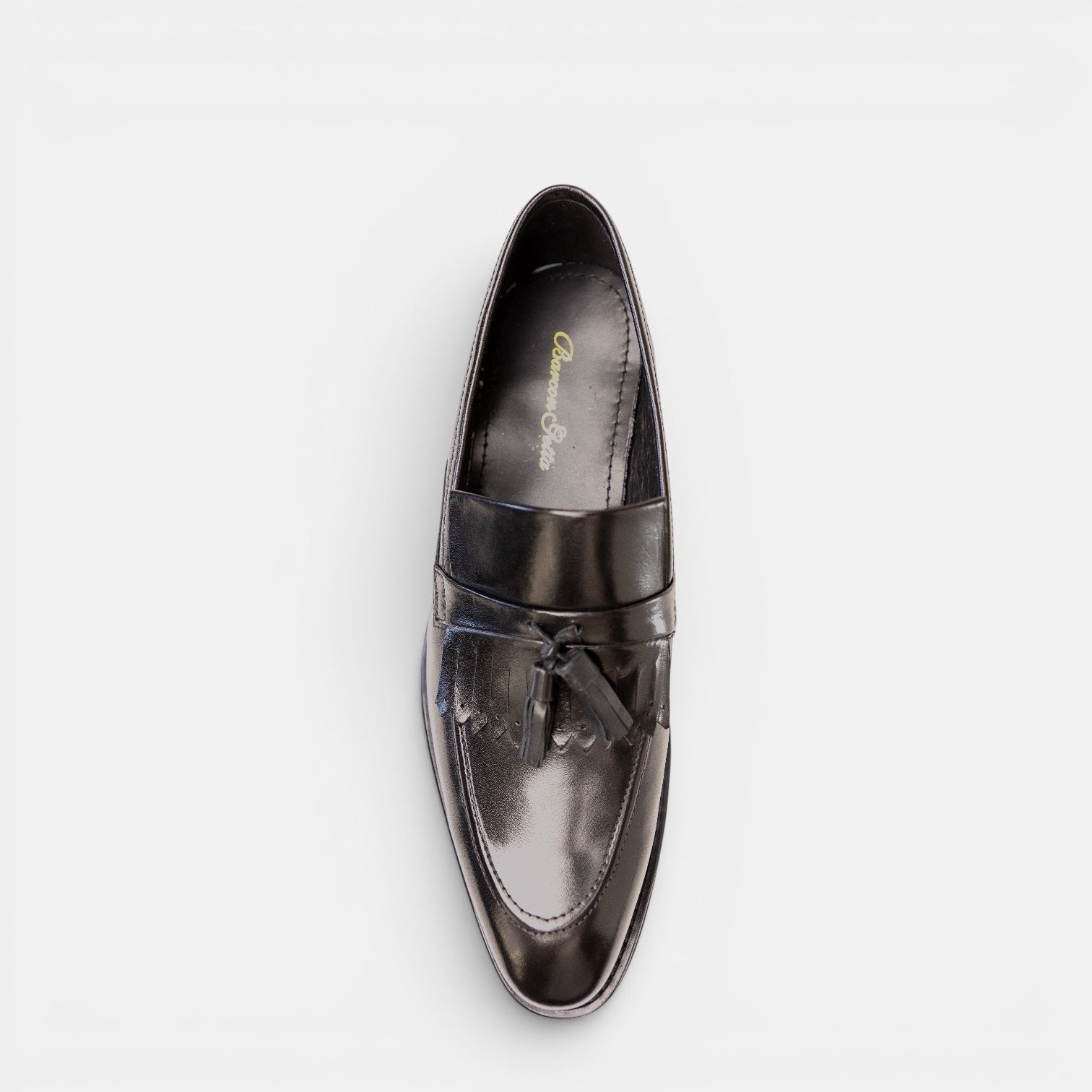 Barcon Getta Inc KUMASSI tassel loafer in high-polish espresso brown full-grain leather. Apron toe with fringed tassel detail.