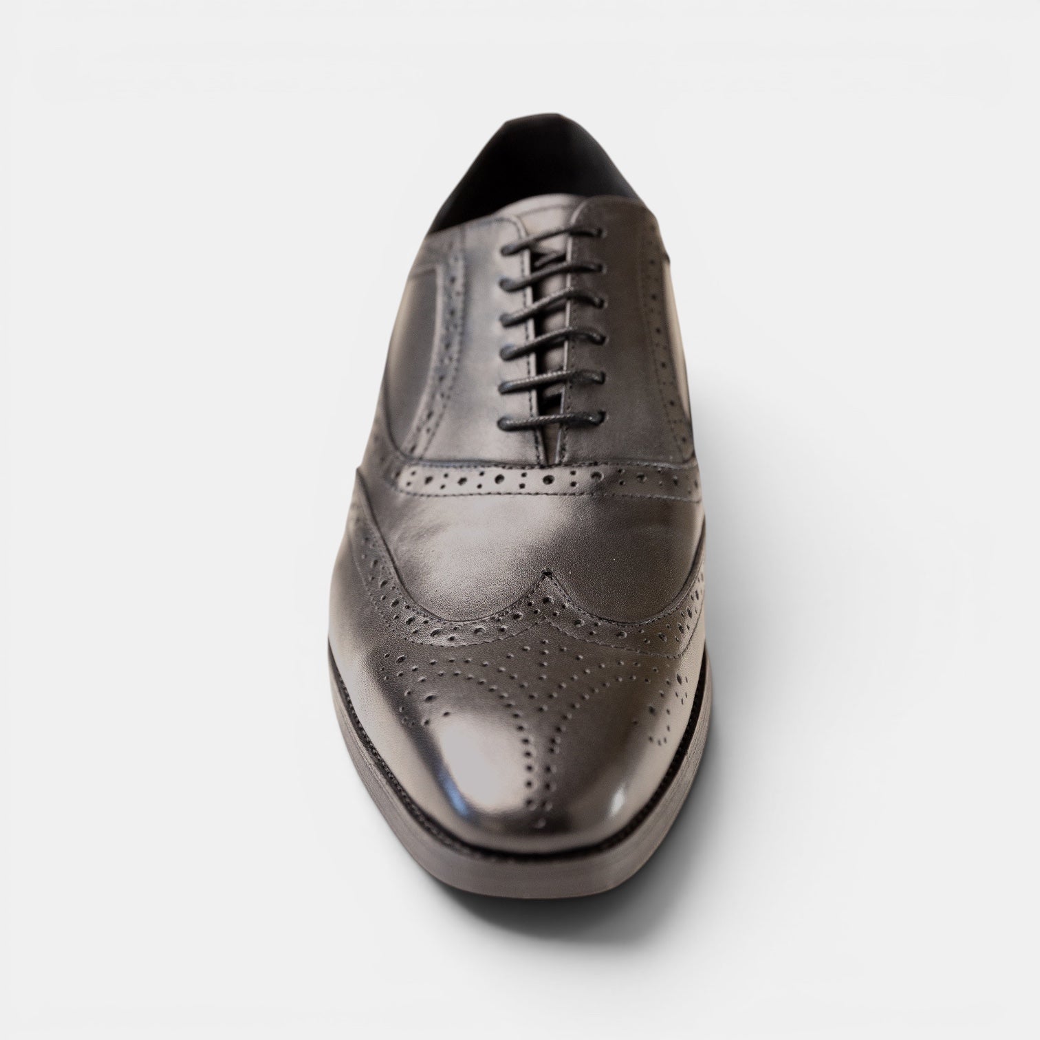 Barcon Getta Inc LOME full brogue wingtip Oxford dress shoes in deep charcoal graphite with blue iridescence. Full grain leather.