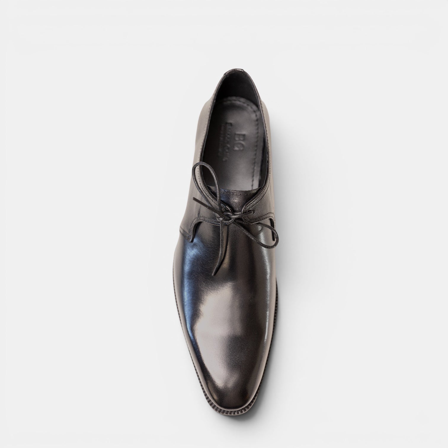 Barcon Getta Inc MALABO single lace derby dress shoe in charcoal black full grain leather with a pointed toe and bow tie closure.