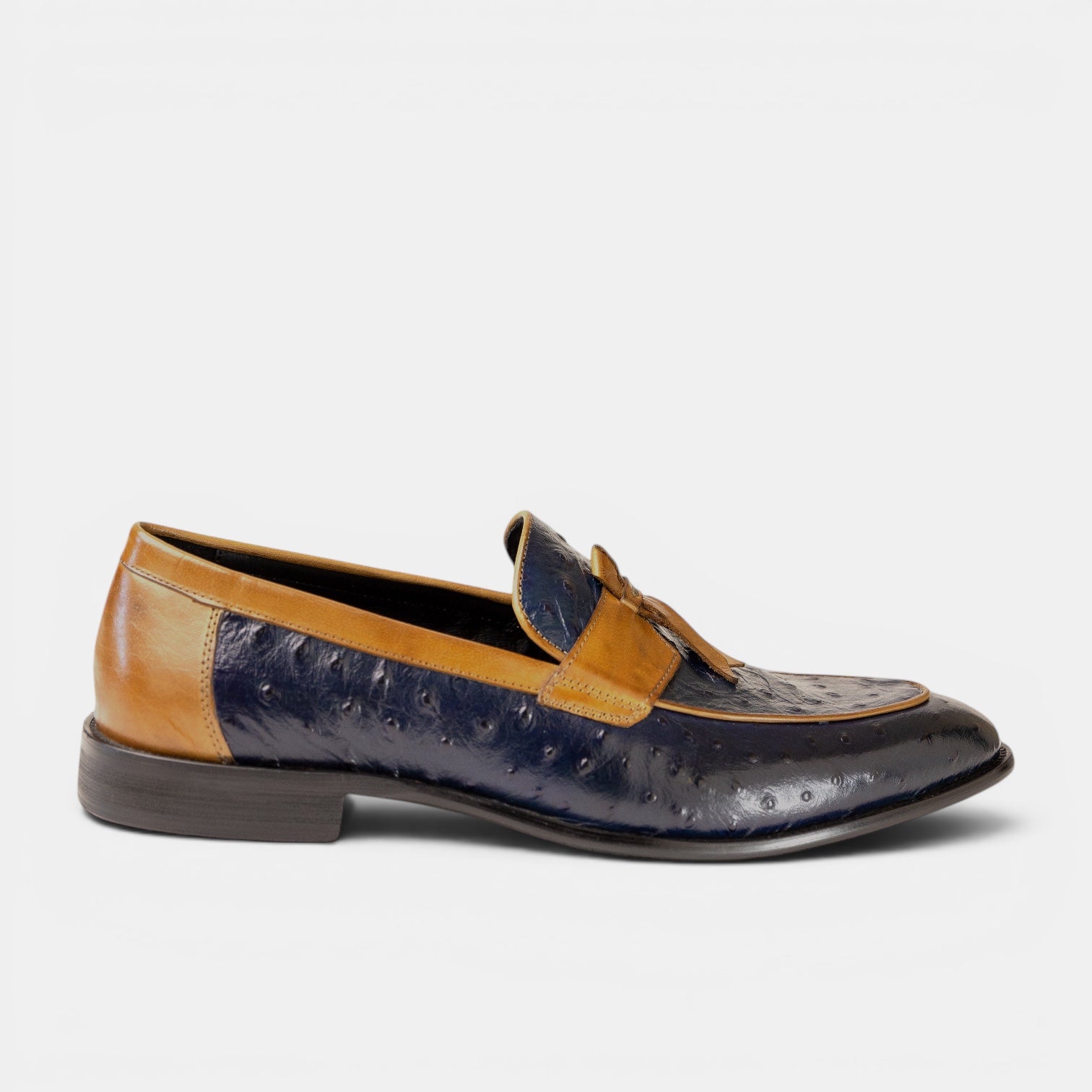 Barcon Getta Inc navy and tan ostrich embossed leather kiltie tassel loafer with a pointed toe and low stacked heel.