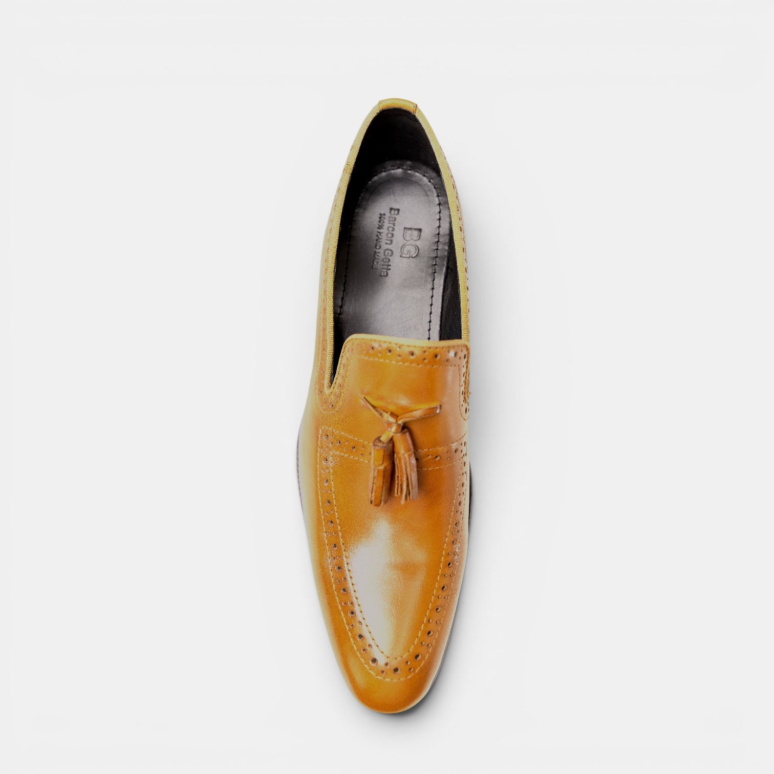 Barcon Getta Inc NEGA tassel loafer in warm tan full grain leather with full brogue detailing and a polished finish.
