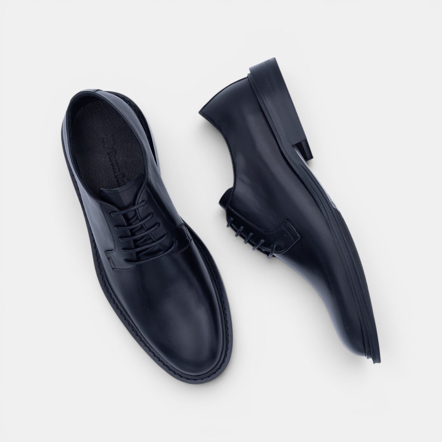 Barcon Getta Inc NYOTA plain toe Derby shoes in black full grain leather with a navy rubber sole.