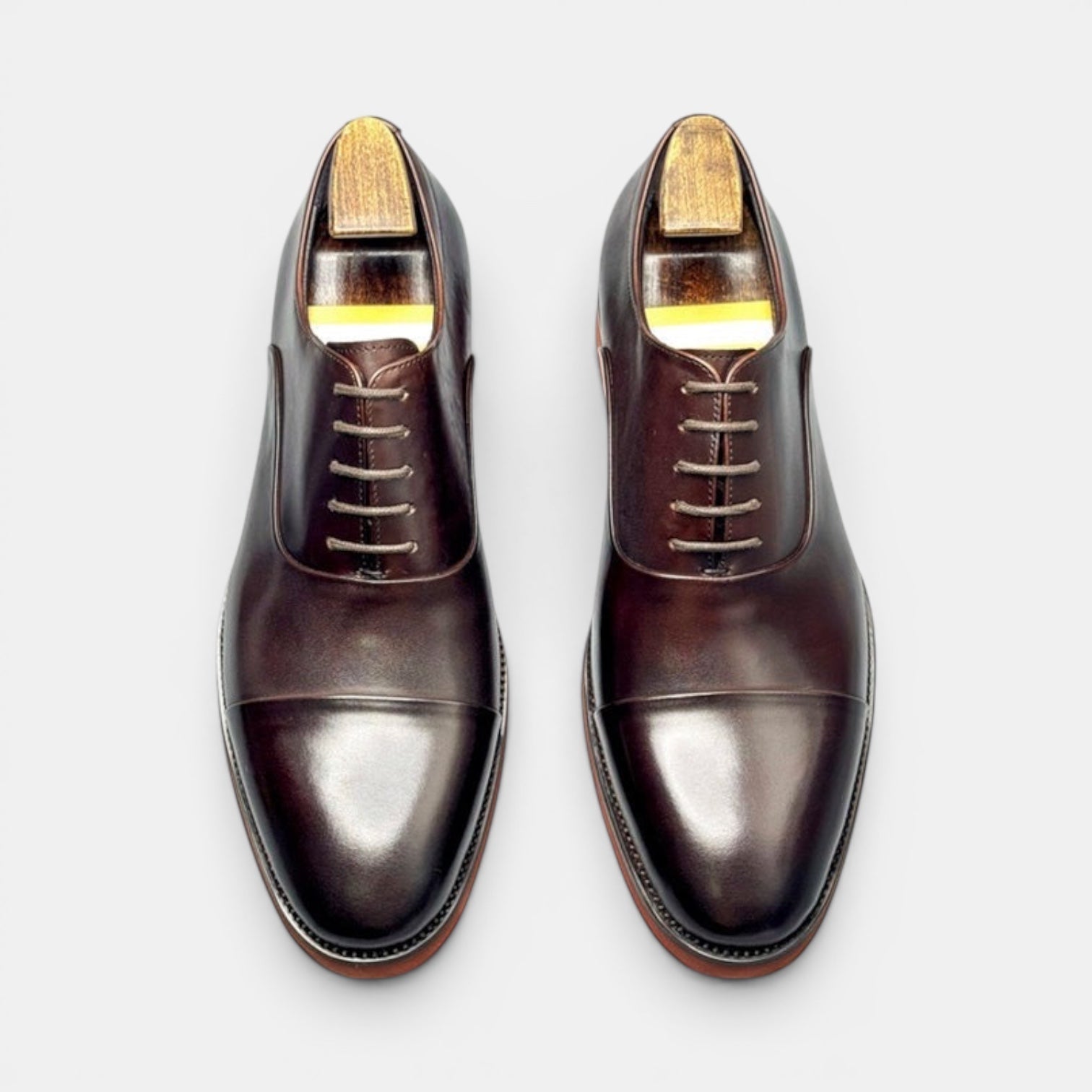 Barcon Getta Inc SAO TOME oxblood brown cap toe Oxford dress shoes made from full grain leather with a mirror-polish finish.