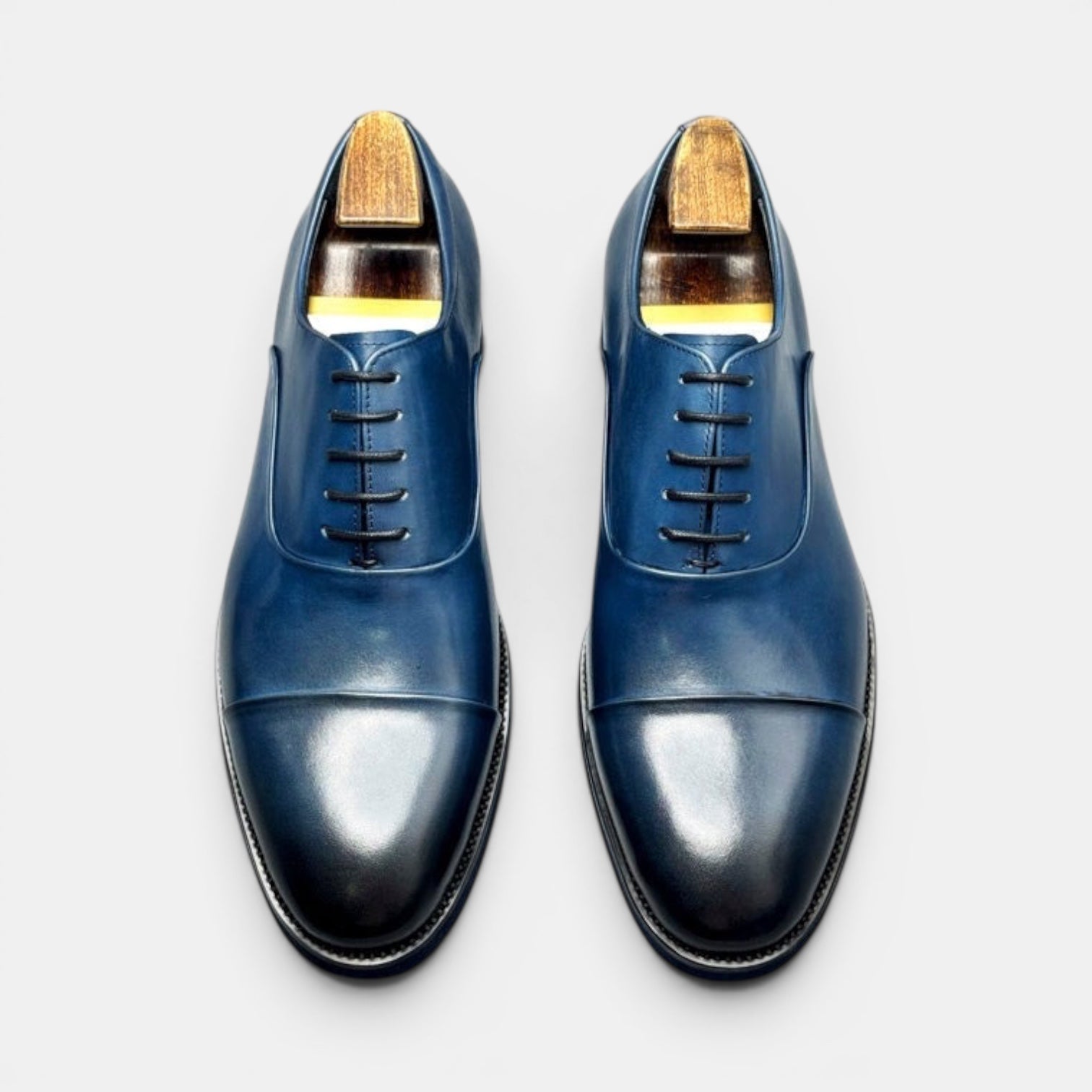 Barcon Getta Inc SAO TOME navy blue leather cap toe Oxford dress shoes with closed lacing and mirror-polish finish.