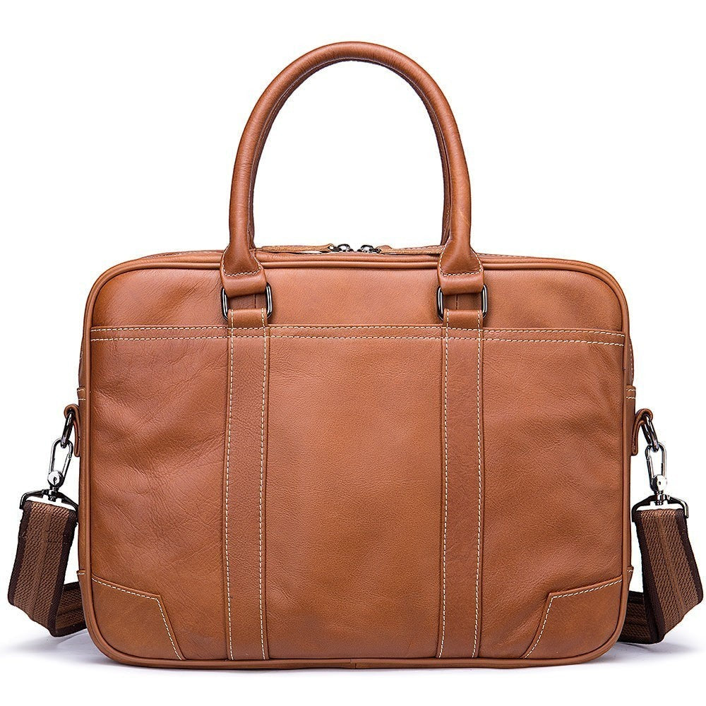 Barcon Getta Inc tan leather briefcase with top handles, detachable strap, and multiple pockets. Fits up to 16" laptop.