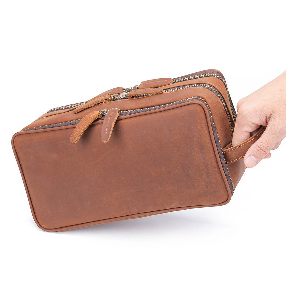 Barcon Getta Inc brown leather travel kit with multiple zippered compartments and a side handle.