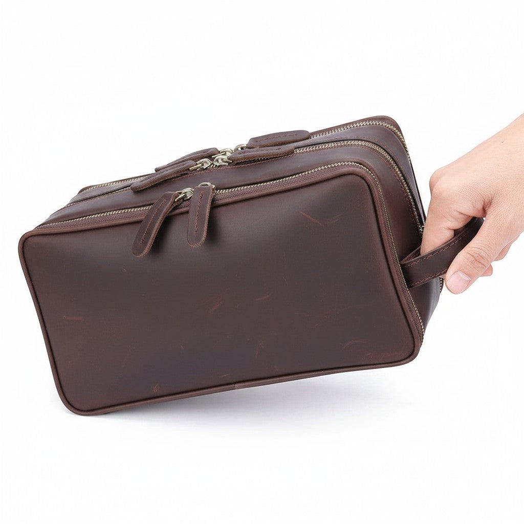 Barcon Getta Inc brown leather travel kit with multiple zippered compartments and a side handle.