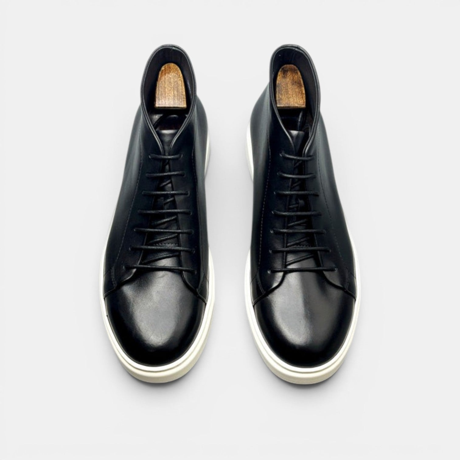 Barcon Getta Inc black leather high top sneakers with white rubber soles and lace-up closure.