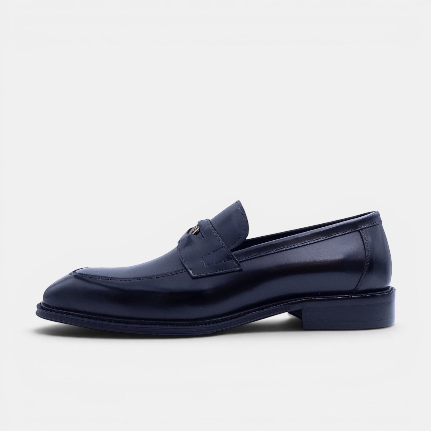 Barcon Getta Inc NEGUS black leather penny loafer with metal accent detail and durable sole.