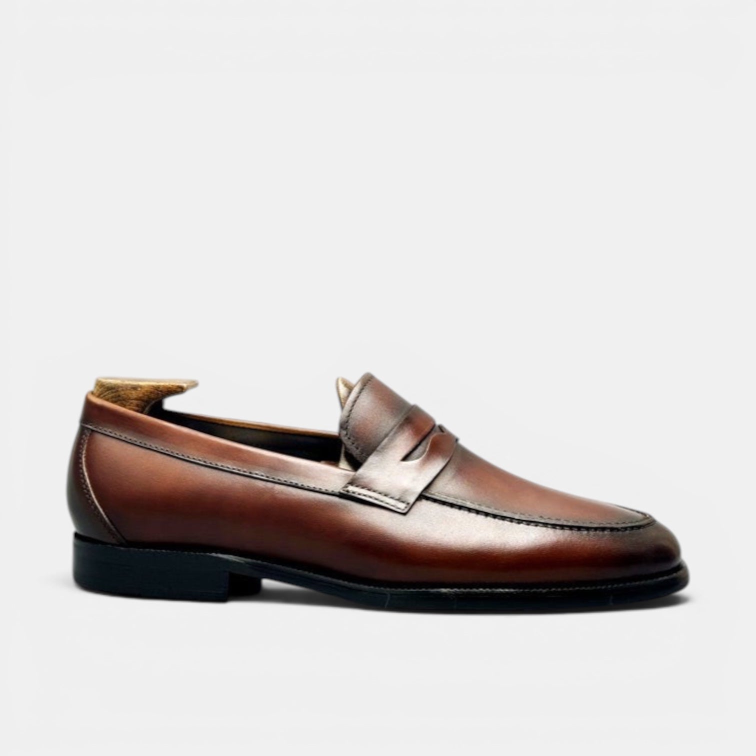 Barcon Getta Inc BANGUI brown polished leather penny loafers with classic strap detail.