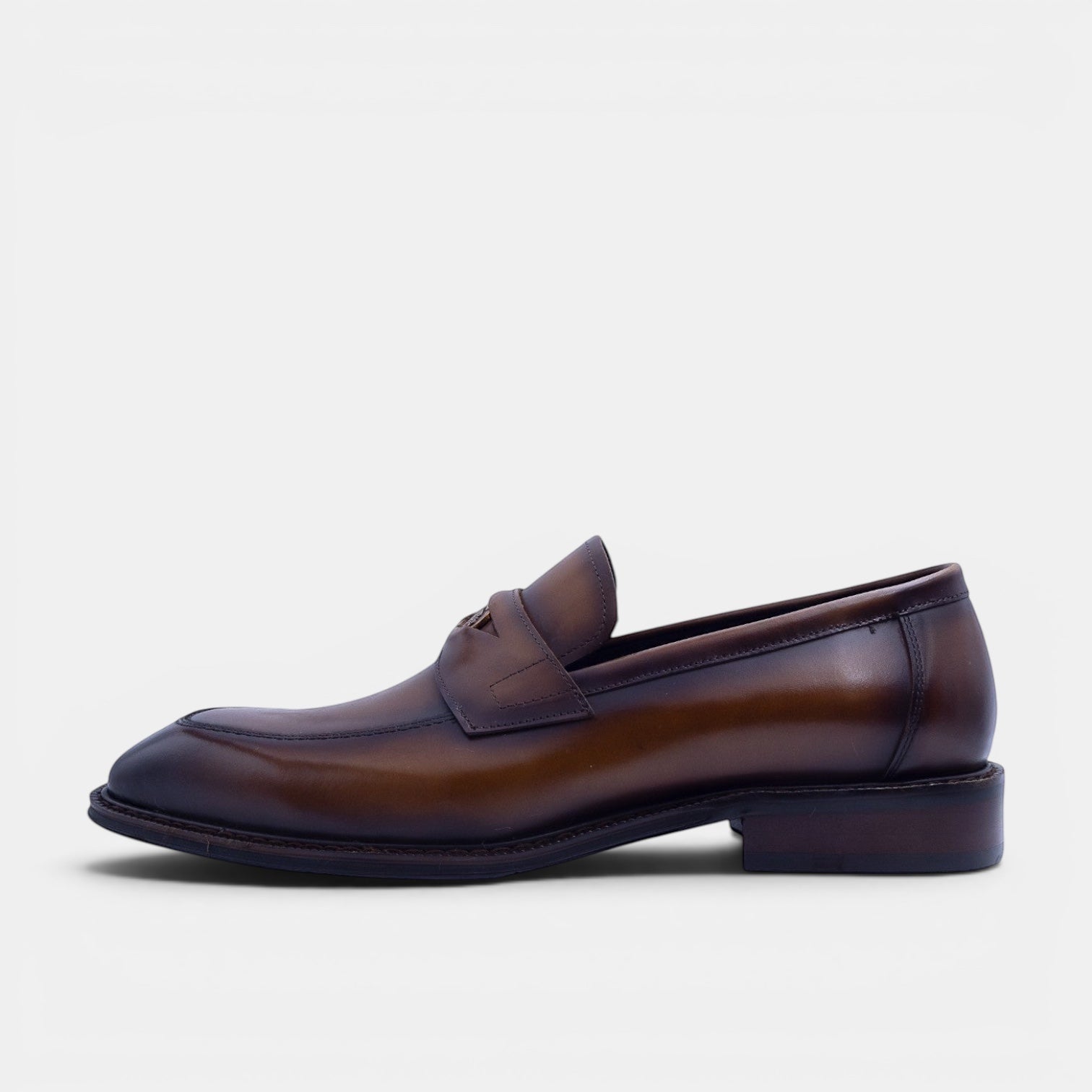 Barcon Getta Inc NEGUS brown leather penny loafer with metal accent and durable sole.