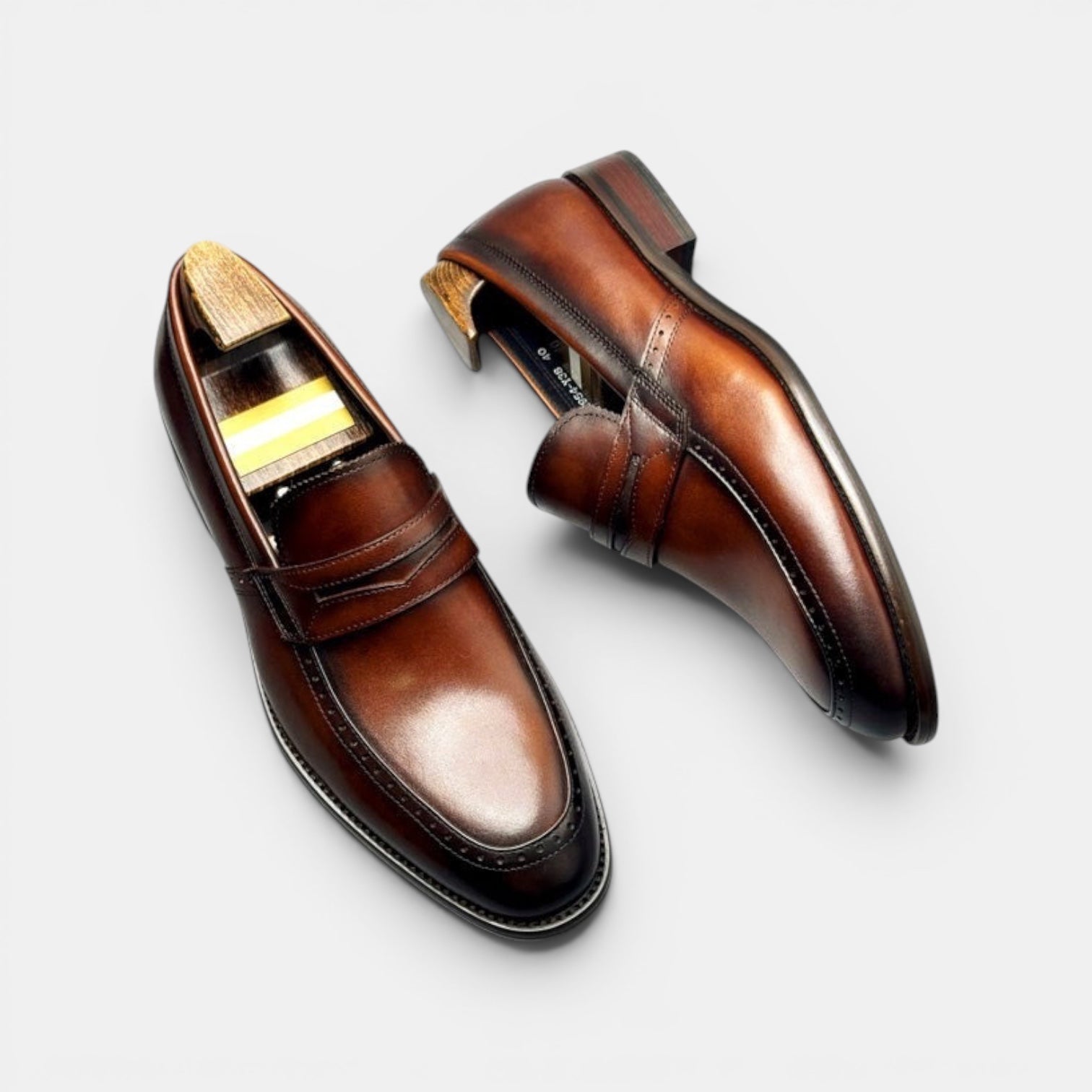 Barcon Getta Inc KINSHASA men's brown leather penny loafers with decorative stitching and polished finish.