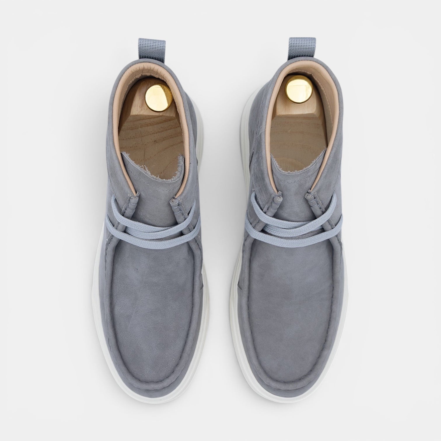Barcon Getta Inc grey suede chukka boots with white rubber soles and light blue laces.