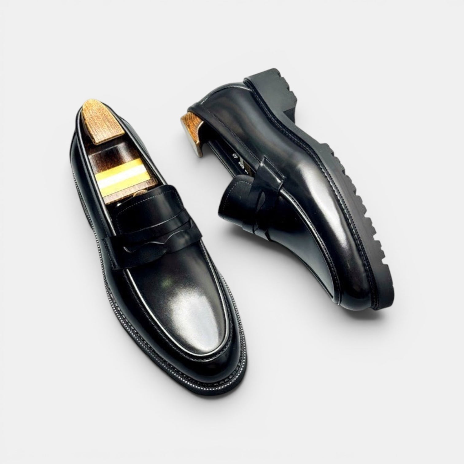 Barcon Getta Inc NIAMEY black polished leather penny loafers with lug sole and modern silhouette.