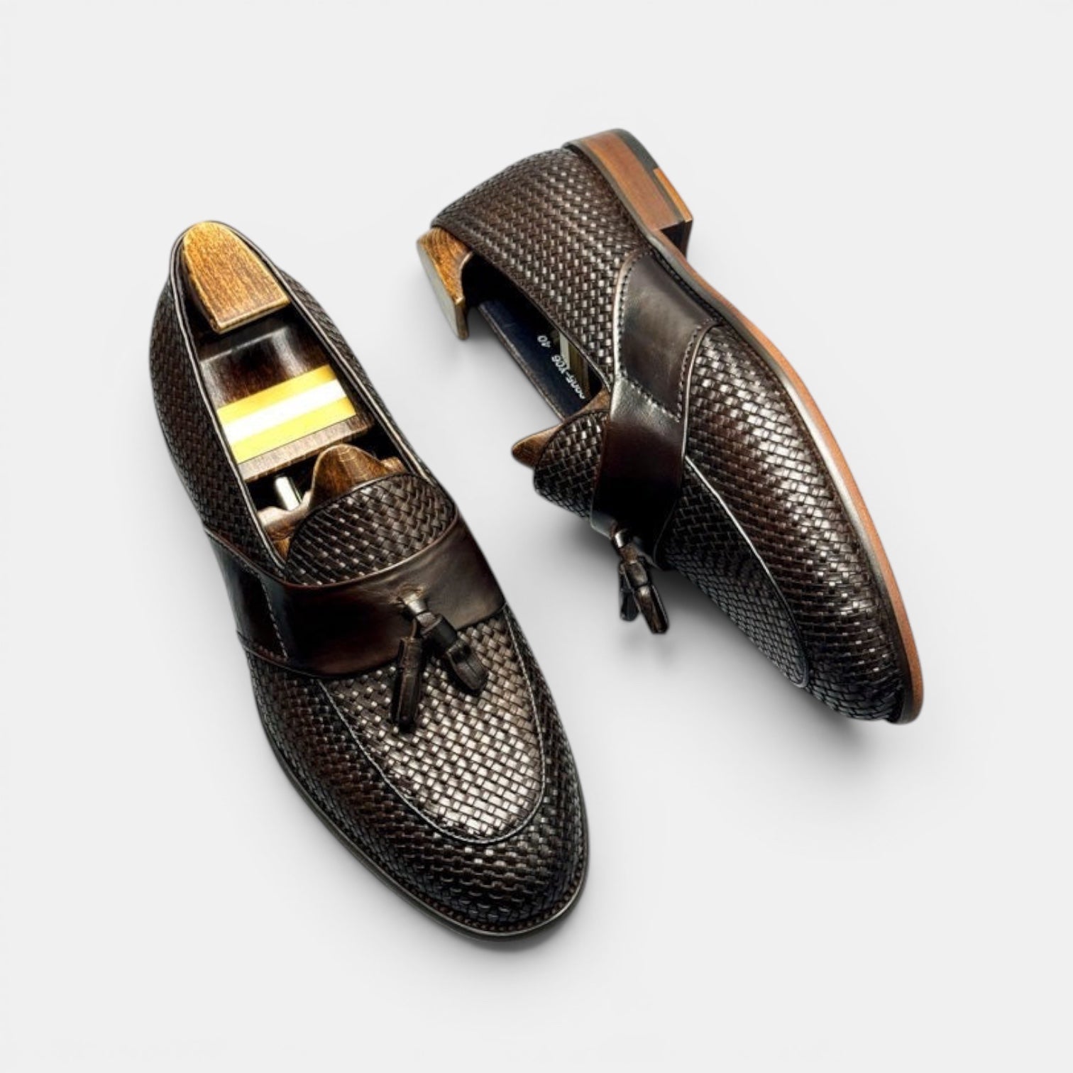 Barcon Getta Inc dark brown woven leather tassel loafers with smooth leather strap detail.