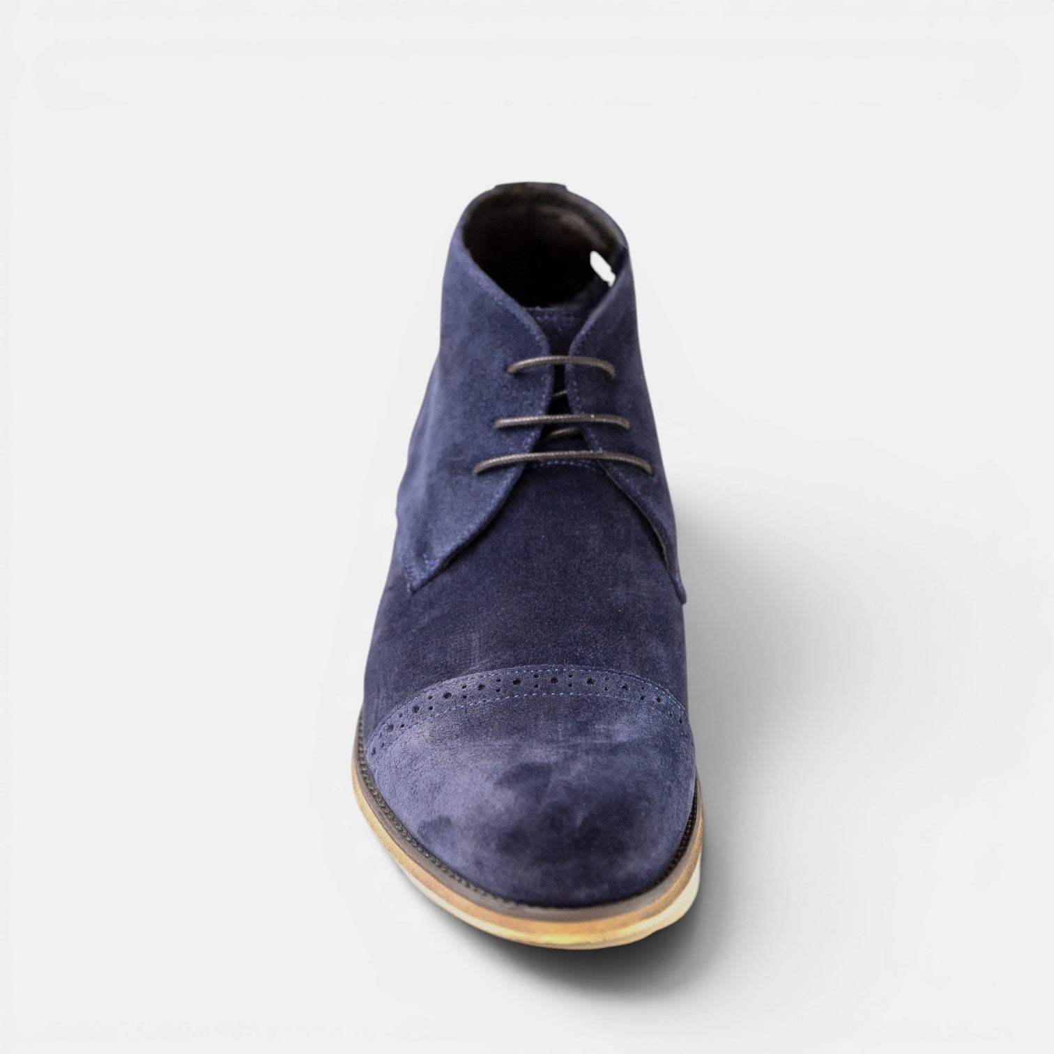 Barcon Getta Inc DJENNE navy suede chukka boots with brogue detailing and lace-up closure.