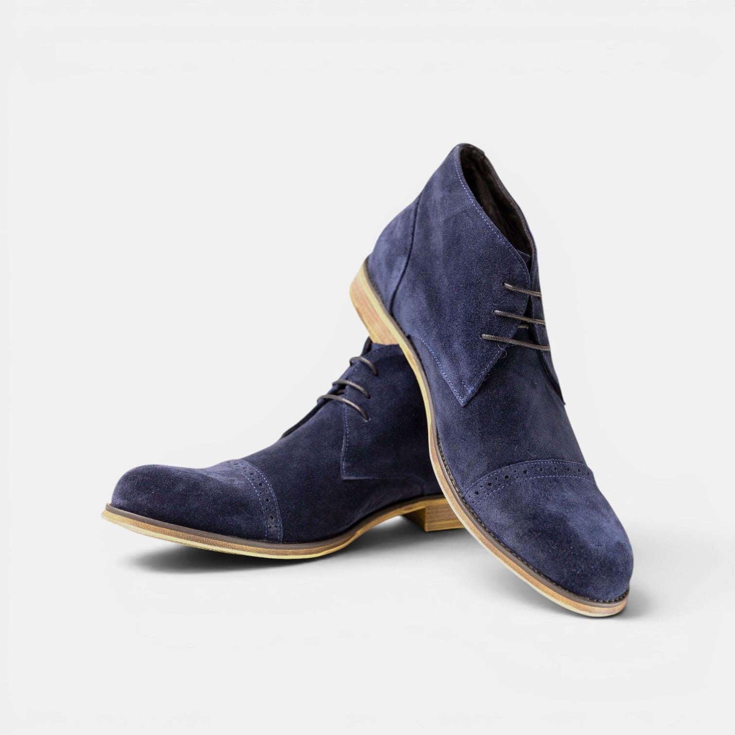 Barcon Getta Inc navy suede chukka boots with brogue detailing and lace-up closure.
