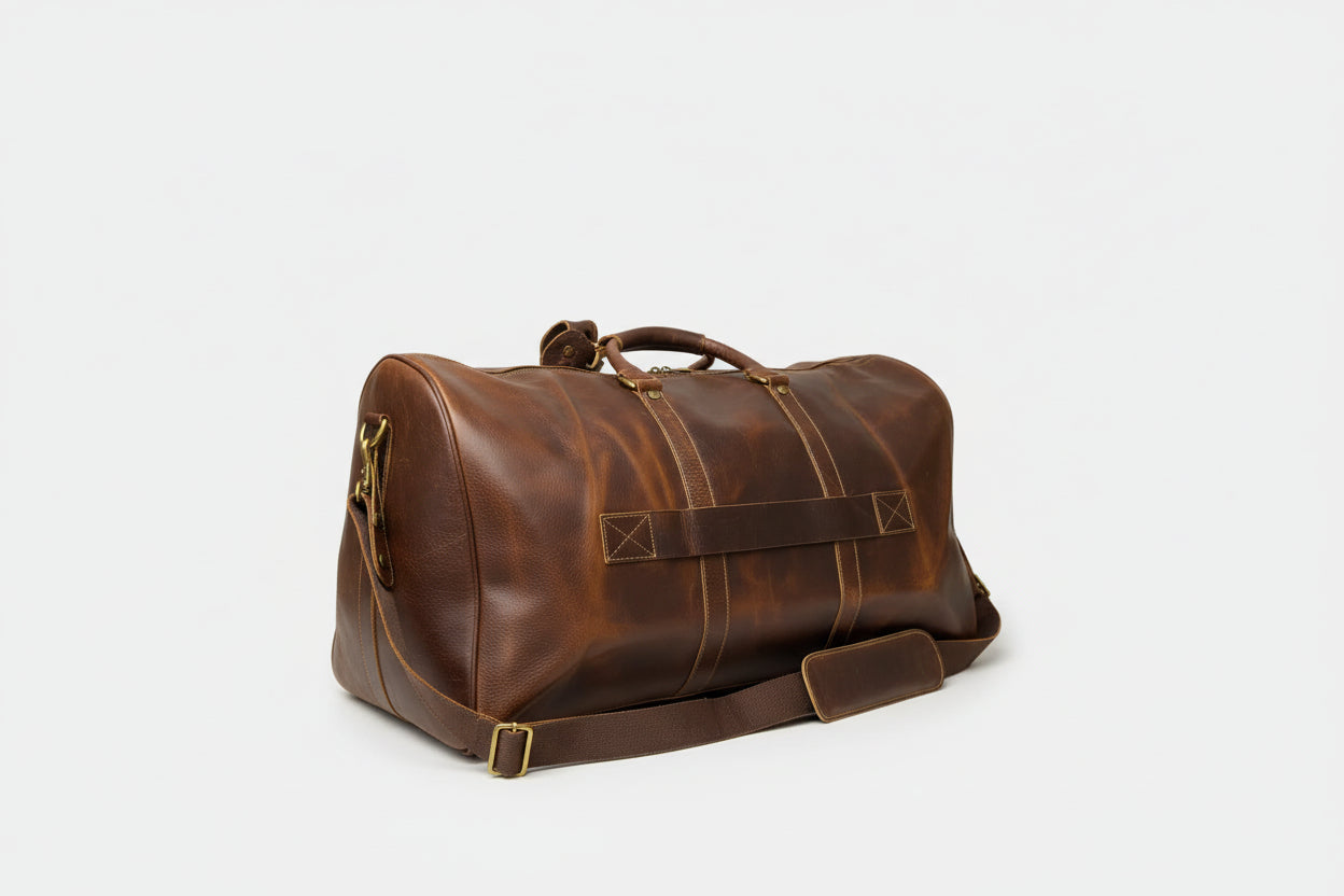 Brown leather duffel bag on a gray background