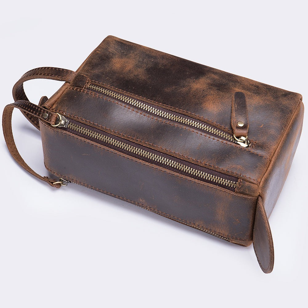 Barcon Getta Inc brown full grain leather dopp case with multiple zippered compartments and a side handle.