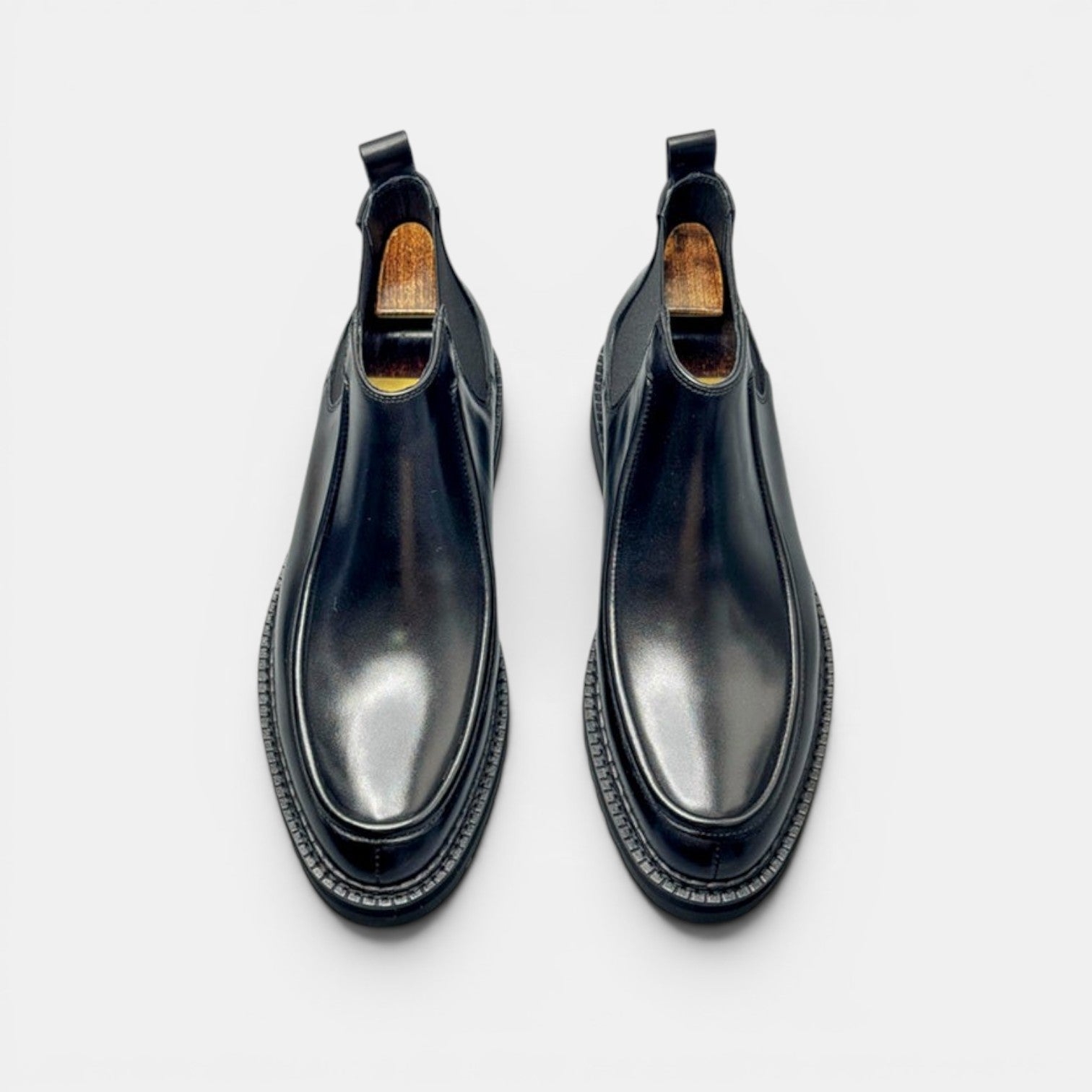 Barcon Getta Inc black leather Chelsea boots with squared toe and lug sole.